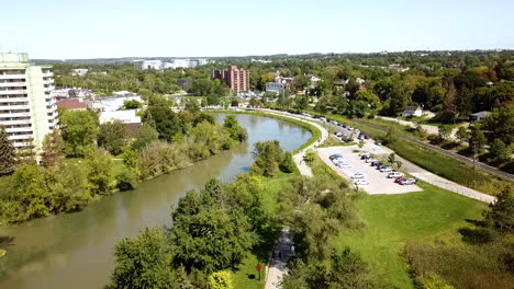 drone flying over a beautiful river in a lush city park