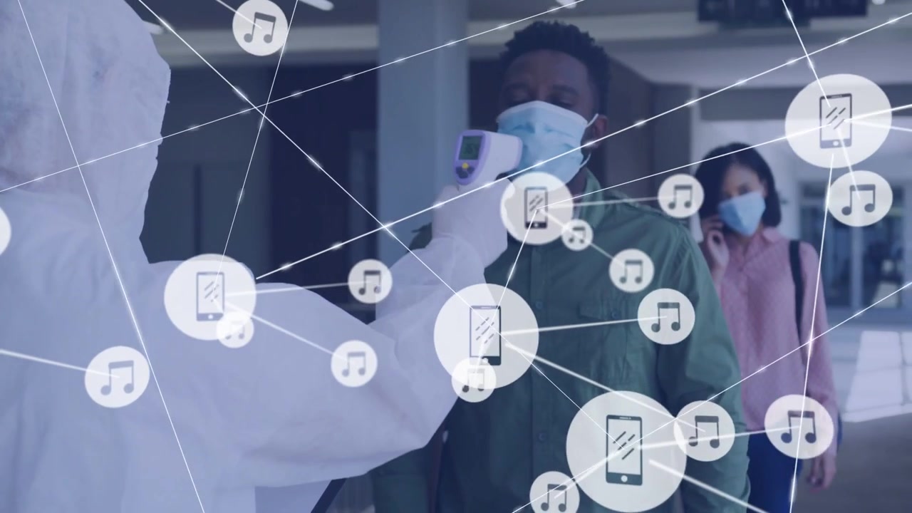 Masked woman showing phone, icons spreading while screener scanning man forehead checking temp