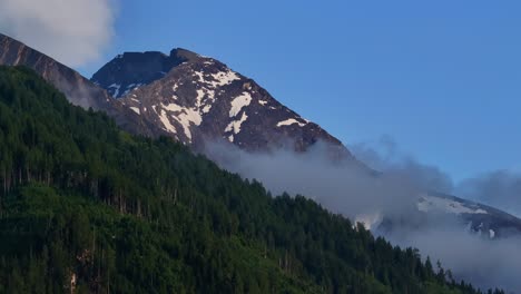 mist on snow and rock covered mountain region