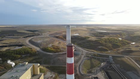 4k-backwards-drone-flight-over-generating-station-in-north-american-countryside-during-colourful-sunset