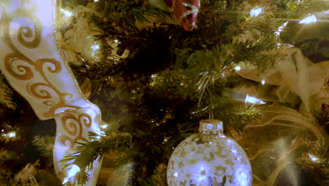 Close-up-sliding-shot-of-a-decorated-Christmas-tree-with-light-leaks