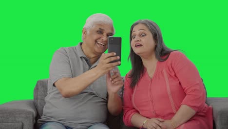 Cute-Old-Indian-husband-clicking-pictures-of-his-wife-Green-screen