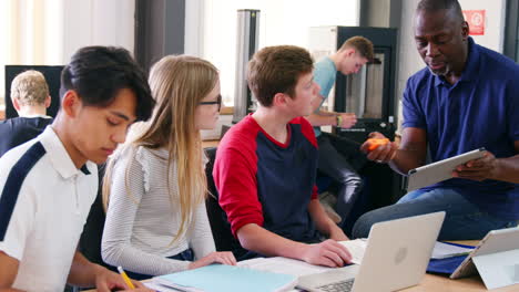 design students with teacher working in cad/3d printing lab