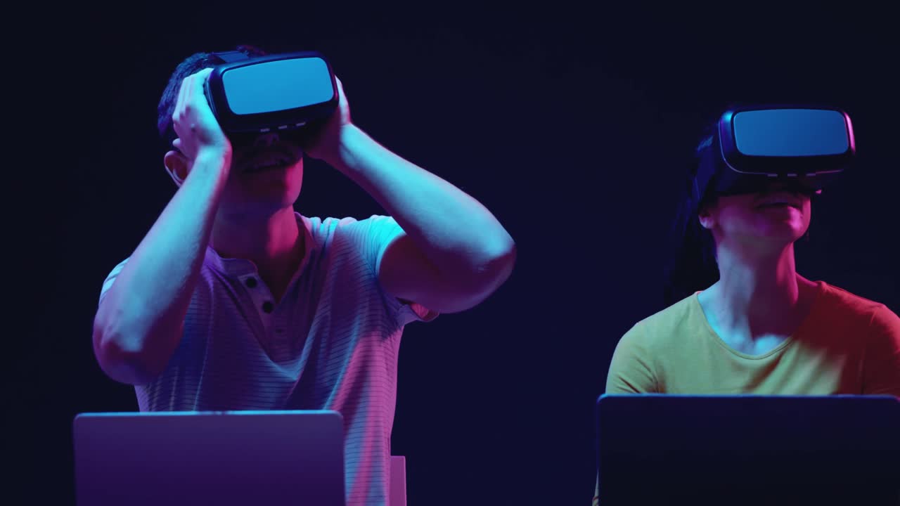 Man and woman wearing VR headsets