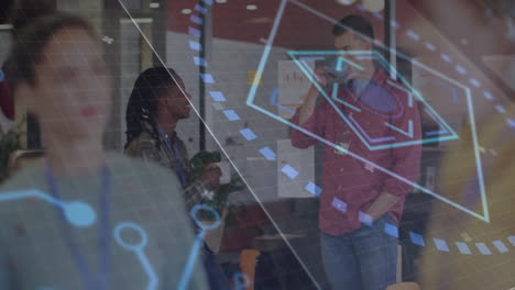 man speaking on smartphone beside glass walls in business office lounge, showing holographic charts