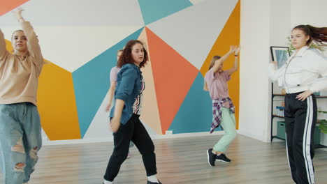 teenage girls dancing in a colorful studio