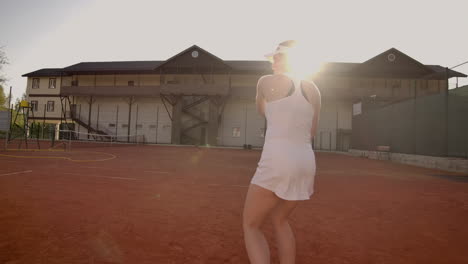 professional equipped female beating hard the tennis ball with tennis racquet. professional equipped female beating hard the tennis ball with tennis racquet