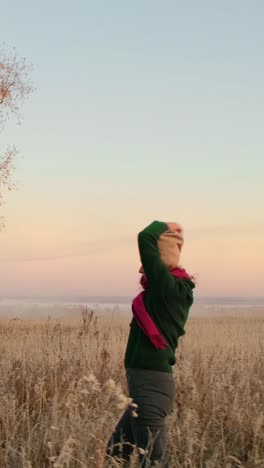 woman enjoying a sunrise in a field
