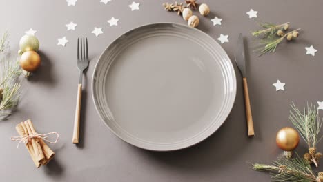 Video-of-christmas-place-setting-with-cutlery-on-grey-background