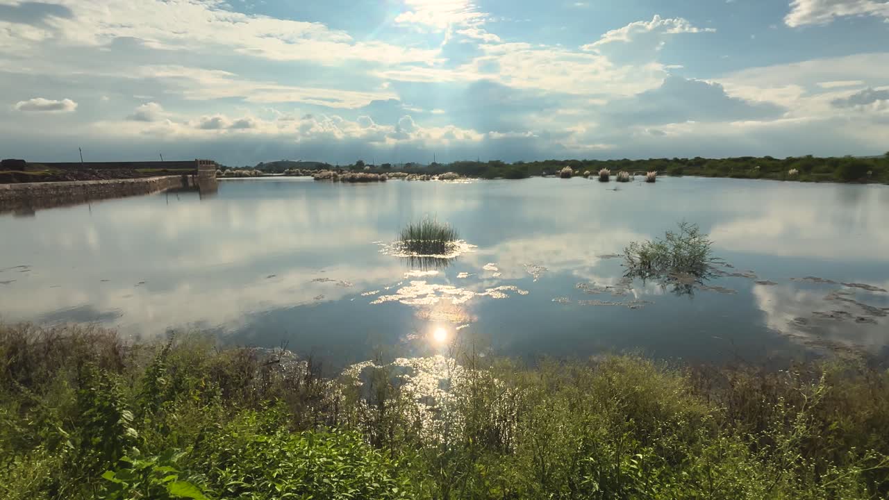 Reflections of a sunny clouded sky in a flooded farmland in madhya pradesh india
