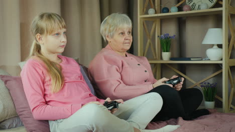 grandmother and granddaughter play video games together 2