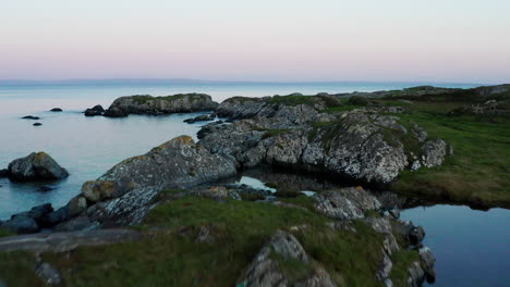 Experience-Connemara's-beauty-with-a-mesmerizing-drone-shot-capturing-lush-green-landscapes-along-the-coast,-accompanied-by-graceful-seagulls-and-birds