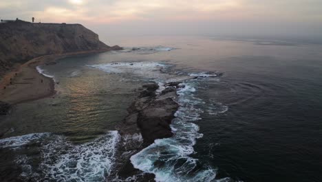 waves crashing off the coast of california