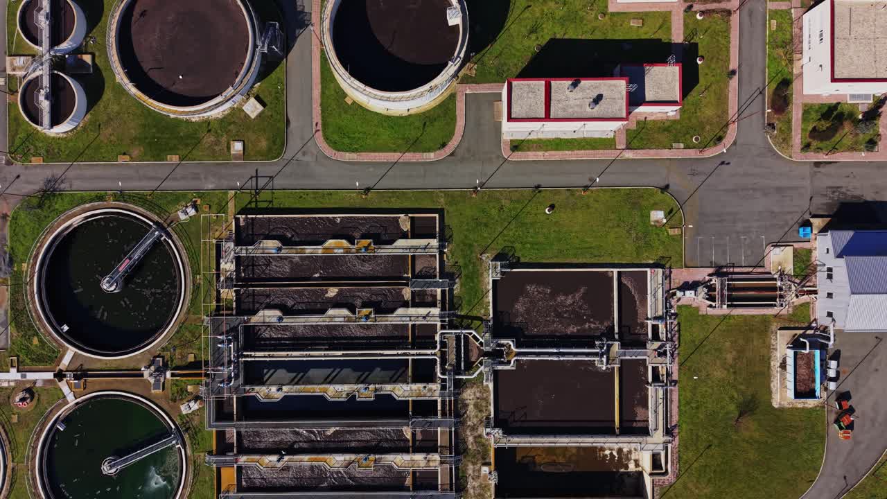 Overview of water treatment facility in the daytime near a city