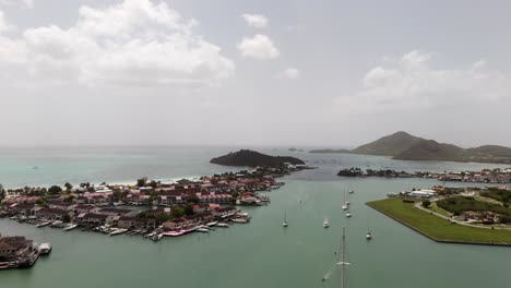 jolly harbor aerial view showing boats, turquoise waters, and coastal town on a sunny day