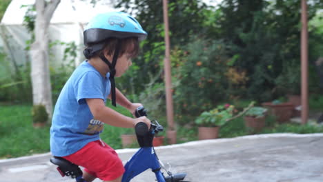 footage of a caucasian little boy learning to ride a bike