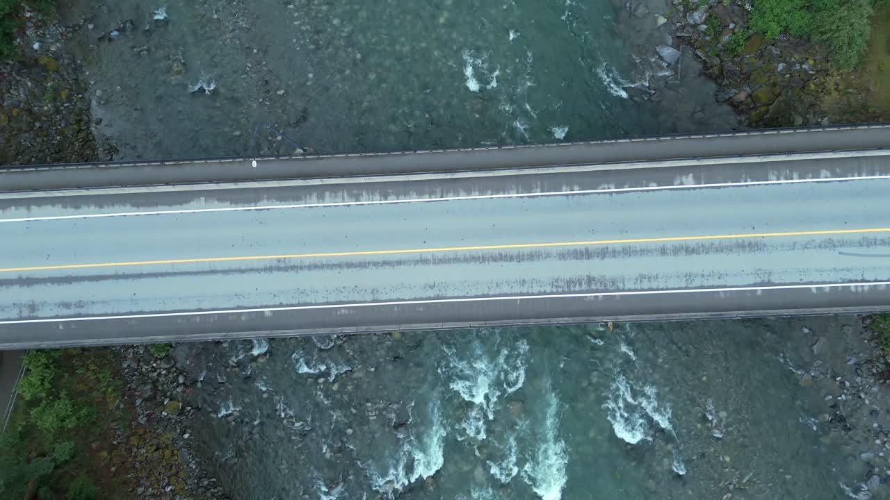 Road Bridge Above Rocky River Near Hope In British Columbia, Canada. Aerial Ascending Shot