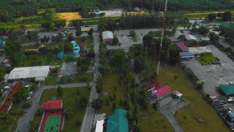 imágenes cinematográficas de drones de efluentes residenciales de molinos de aceite de palma consisten en edificios, casas, carreteras principales e infraestructura rodeadas de deforestación de árboles de aceite de palma ubicados en indonesia en full hd