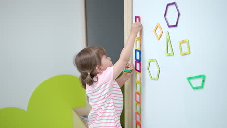 Toddler-Girl-Playing-With-Magnetic-Square-Tiles