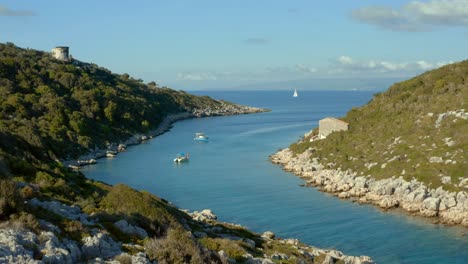 paxi island coast with boats in tropical lagoon in greece, aerial