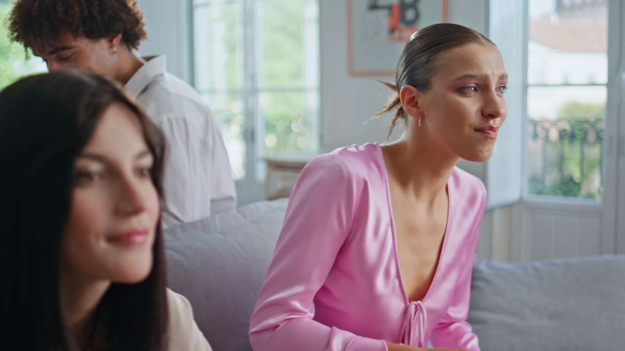 Two girls holding joysticks playing video game at home closeup. Gamers competing