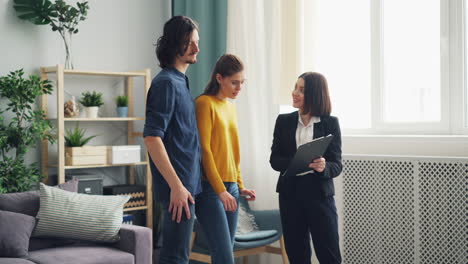 real estate agent showing a house to a couple
