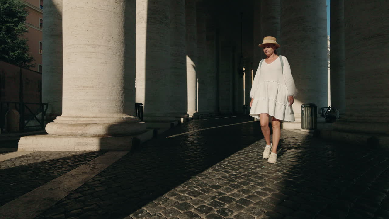 Woman walking among columns