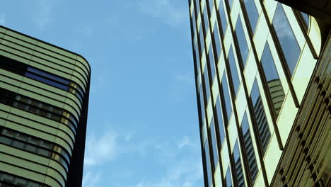 modern skyscrapers with reflective glass facades against blue sky