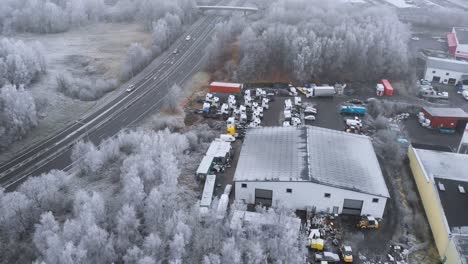 industrial storage warehouse in wintertime - aerial orbit