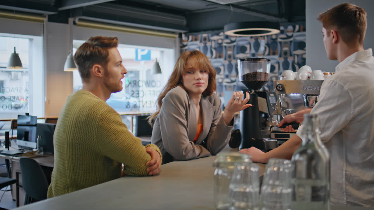 Businesspeople talking bartender ordering coffee at bar. People resting in cafe