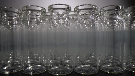 rows of empty clear glass vials