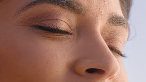 close up beautiful eyes hispanic woman looking at ocean view enjoying natural beauty contemplating future enjoying freedom