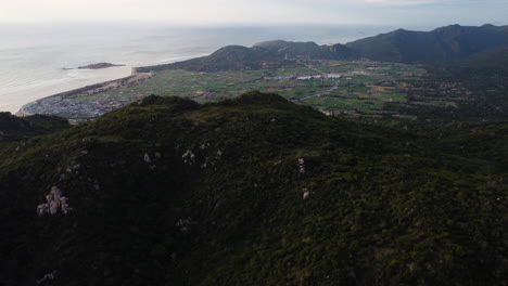 Aerial-coastline-seascape-view-of-ninh-thuan-province-vietnam,-Nui-Chua-national-park,-drone-reveal-natural-mountains-valley-with-fisherman-village-and-ocean-view