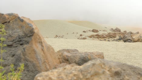 desertic rocky terrain in teide national park, low visibility deep fog