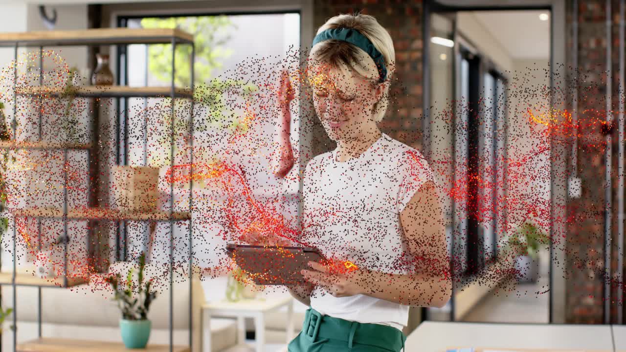 Woman holding tablet at home raising browsing while particle cloud flowing across bands for tech