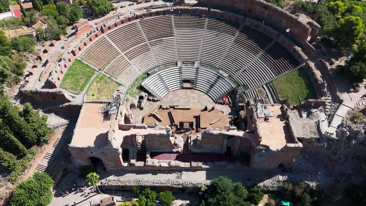 Drone pans up close to the amphitheatre, showcasing detailed stone structures, arches, and historic architectural design