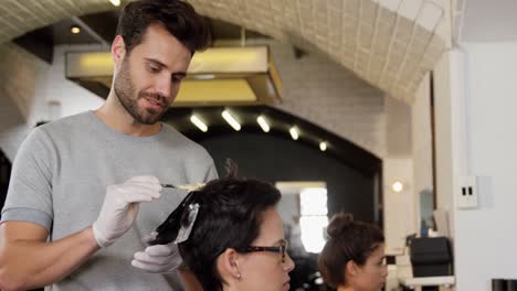 peluquero teñir el cabello del cliente