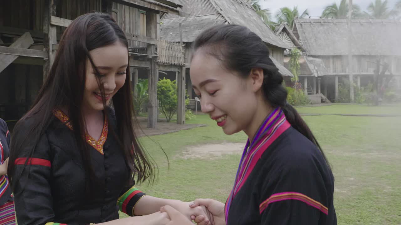 Thai Women in Traditional Costumes Performing a Dance