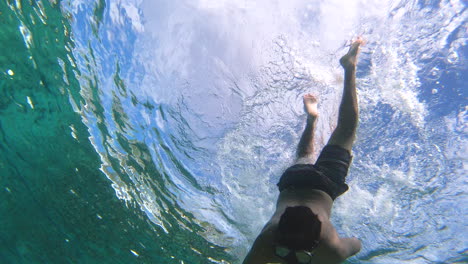 snorkelling and diving in the blue ocean with action cam in playa chen rio, cozumel island, riviera maya, mexico