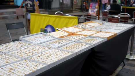 outdoor jewelry market stall with many rings for sale