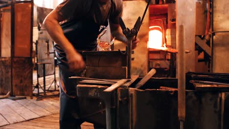 glassblower shaping a molten glass