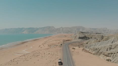 aerial view of makran coastal highway road near beach of gulf of oman. dolly back