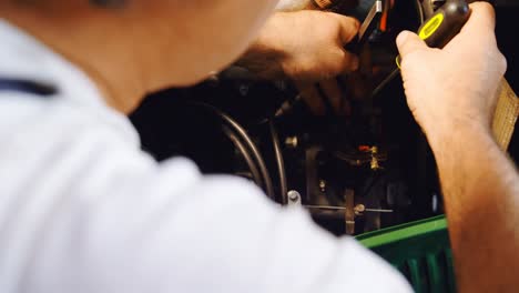 male mechanic servicing a car in garage 4k