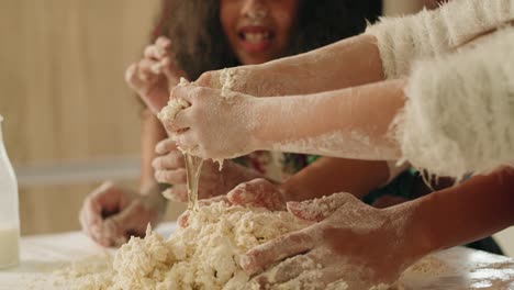 Handheld-view-of-mother-and-her-daughter-kneading-dough