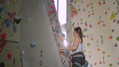 lens flare: bright sunbeams shine on a girl climbing a route in an indoor center