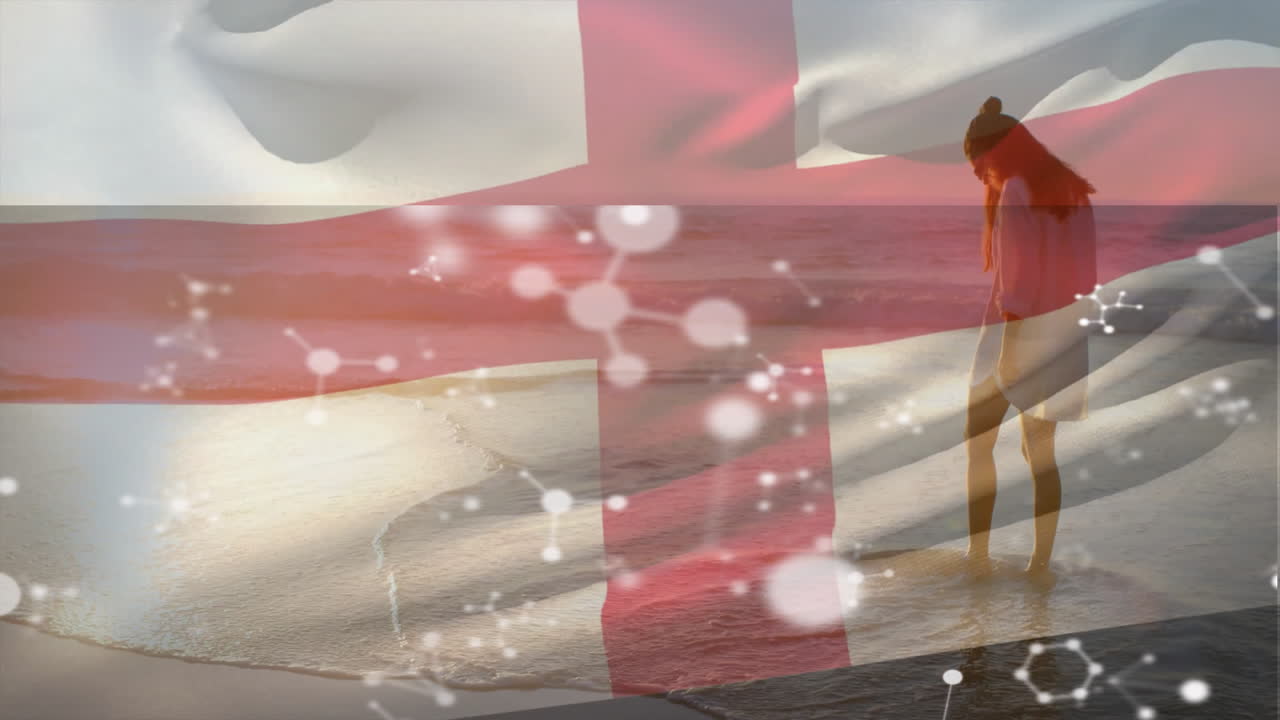 Walking on beach, woman holding England flag with molecular structure animation