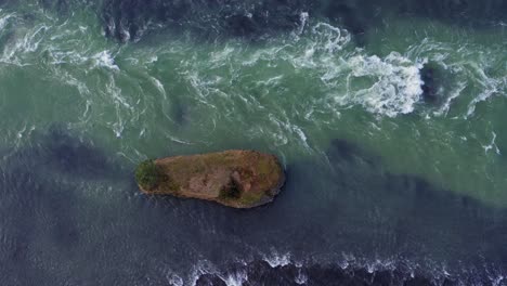 water cascading down the river of olfusa with an islet near selfoss, iceland