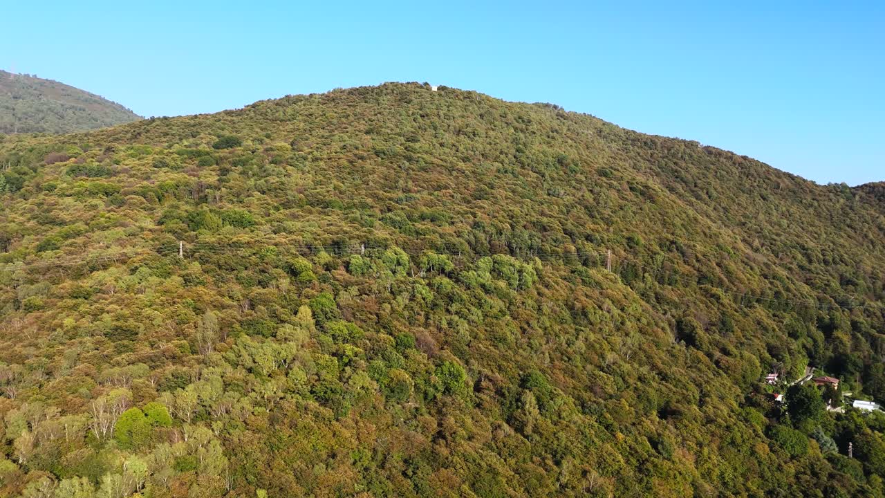 Fly upwards along green mountain in Italy, summer time