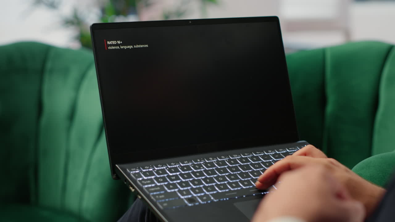 Bucharest, Romania - July 30th 2024 - Young CEO using Netflix to relax in office