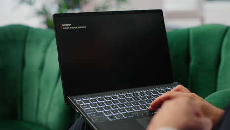 bucharest, romania - july 30th 2024 - young ceo using netflix to relax in office